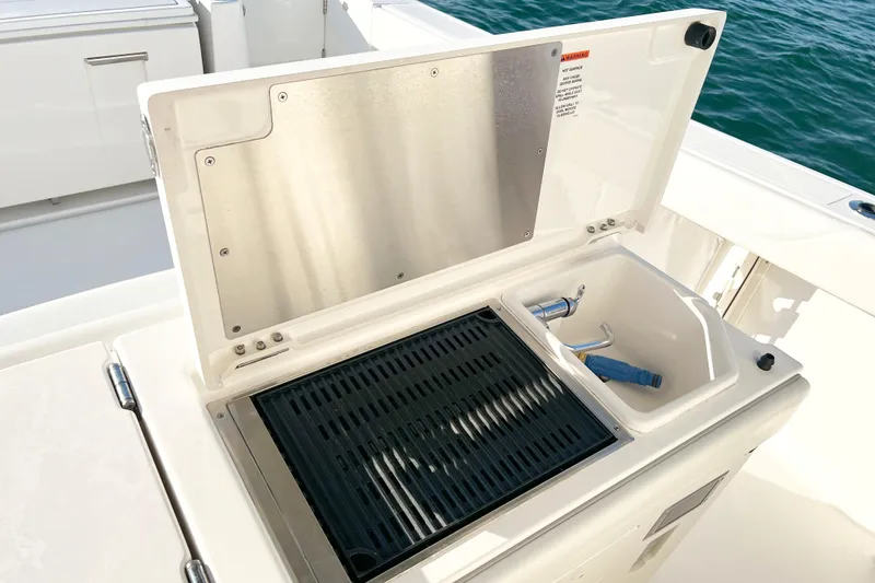 Slide: The Image of 2023 Pursuit S 378 Sport boat grill and sink setup on deck. - 23
