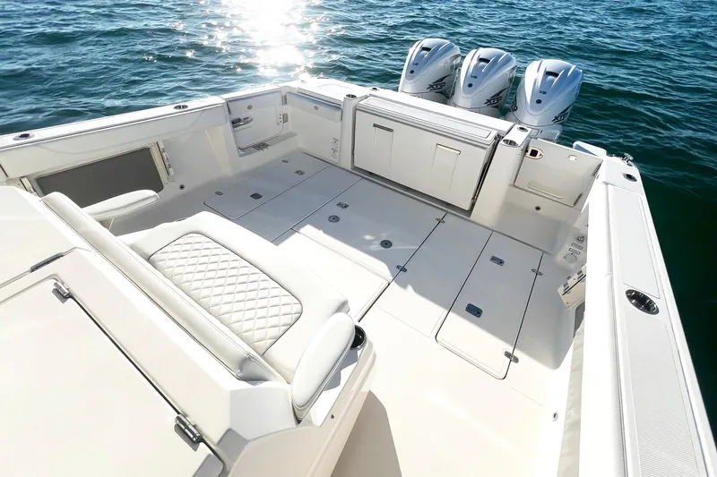 Slide: The Image of 2023 Pursuit S 378 Sport boat deck with triple engines on open water. - 24