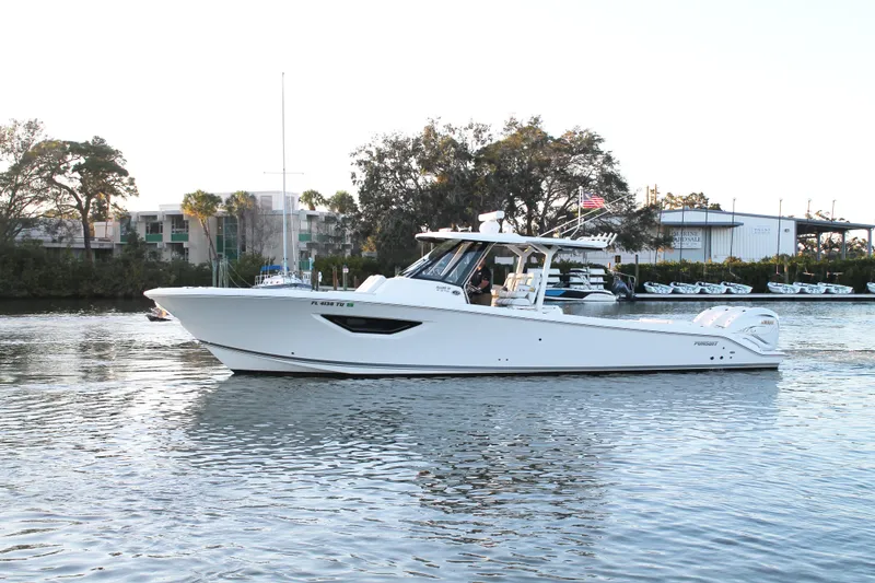 Slide: The Image of 2023 Pursuit S 378 Sport boat cruising on a calm river. - 3