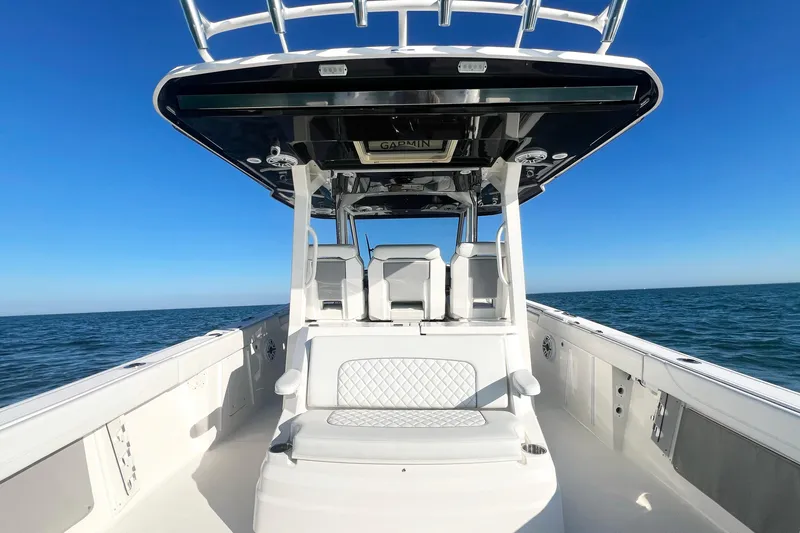 Slide: The Image of 2023 Pursuit S 378 Sport boat on open water under clear blue sky. - 30