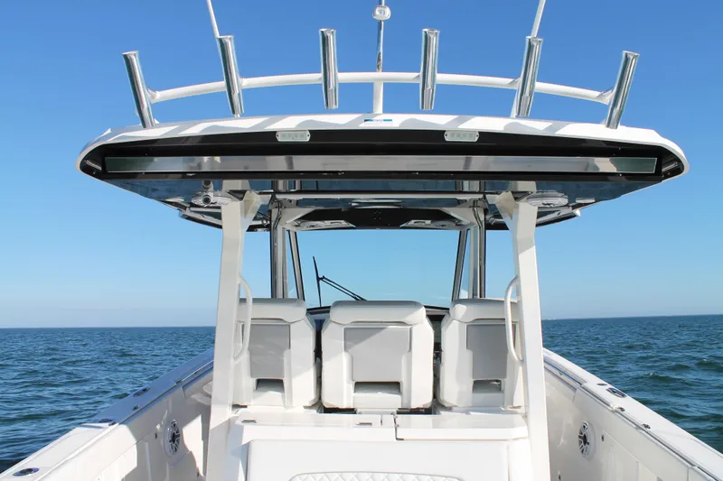 Slide: The Image of 2023 Pursuit S 378 Sport boat on open water, featuring sleek design and spacious seating. - 31