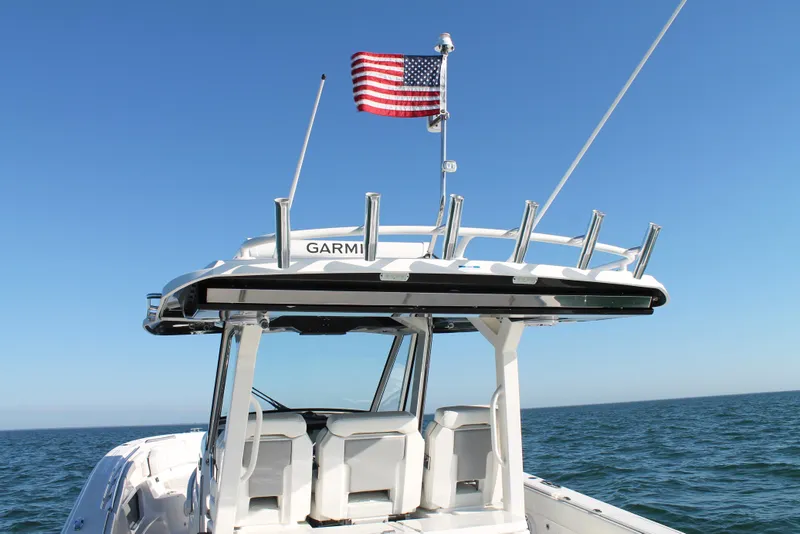 Slide: The Image of 2023 Pursuit S 378 Sport boat with American flag on open sea. - 32
