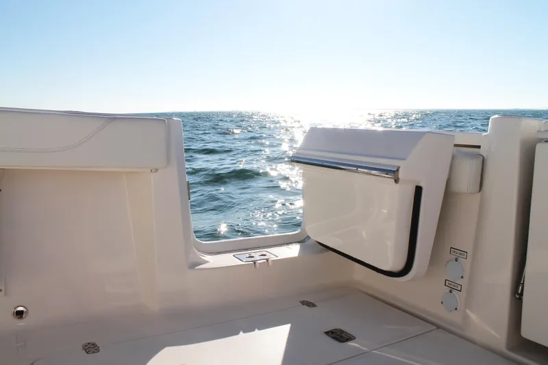 Slide: The Image of 2023 Pursuit S 378 Sport boat interior with ocean view and sunlight reflection. - 34