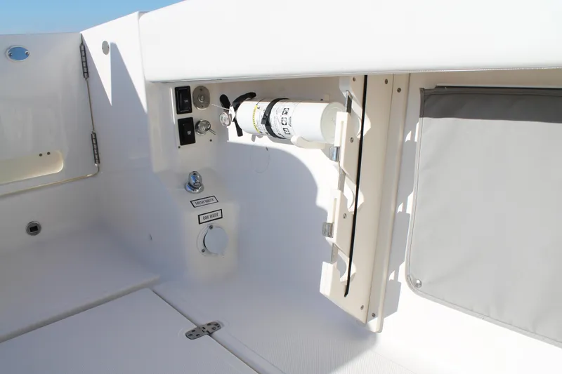 Slide: The Image of 2023 Pursuit S 378 Sport boat interior with utility panel and storage compartment. - 37