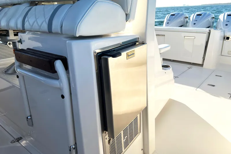 Slide: The Image of 2023 Pursuit S 378 Sport boat interior with seating and stainless steel refrigerator. - 38