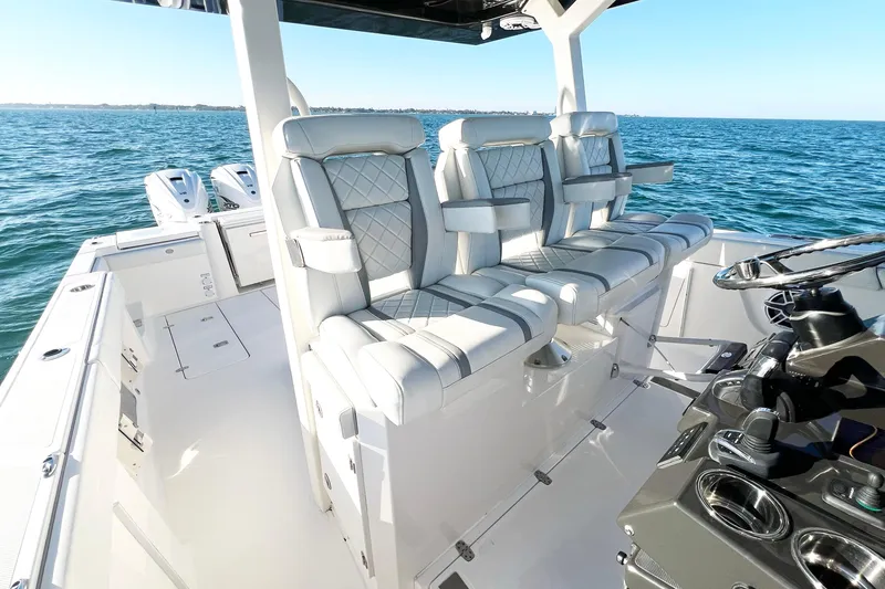 Slide: The Image of 2023 Pursuit S 378 Sport boat interior with luxurious seating and modern controls on open water. - 39