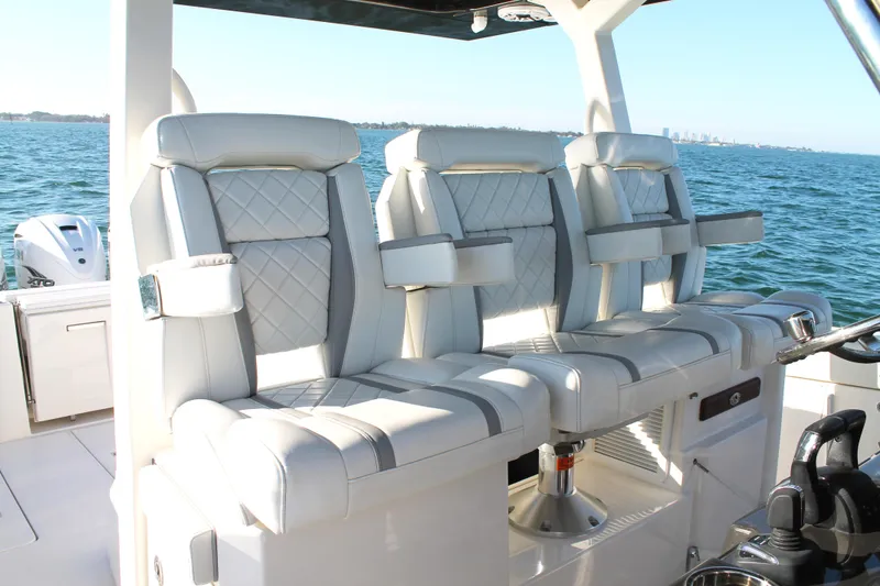 Slide: The Image of Luxurious seating on 2023 Pursuit S 378 Sport boat, featuring elegant design and ocean backdrop. - 41