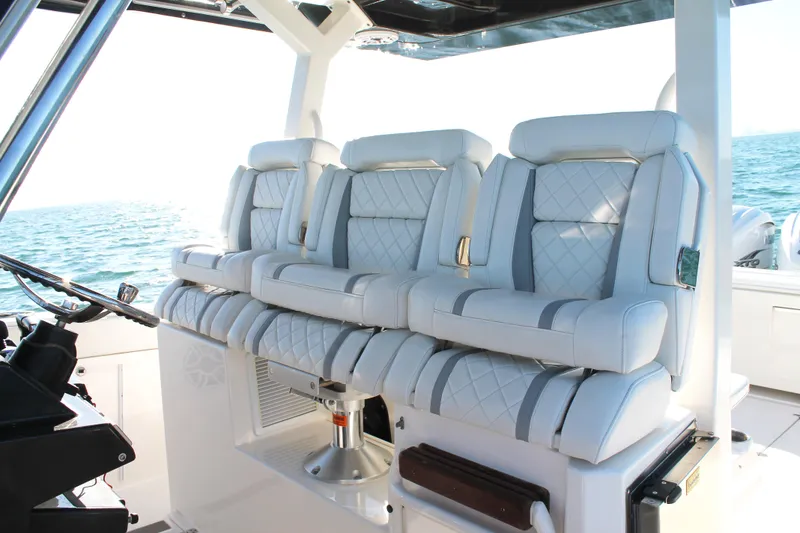 Slide: The Image of Luxurious seating on 2023 Pursuit S 378 Sport boat with ocean backdrop. - 42