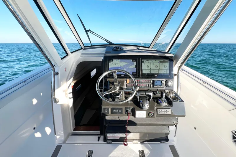 Slide: The Image of 2023 Pursuit S 378 Sport boat cockpit with advanced navigation system and ocean view. - 43