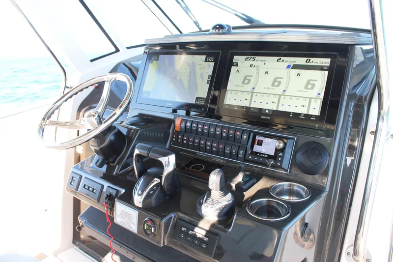 Slide: The Image of 2023 Pursuit S 378 Sport boat dashboard with advanced navigation and control systems. - 45