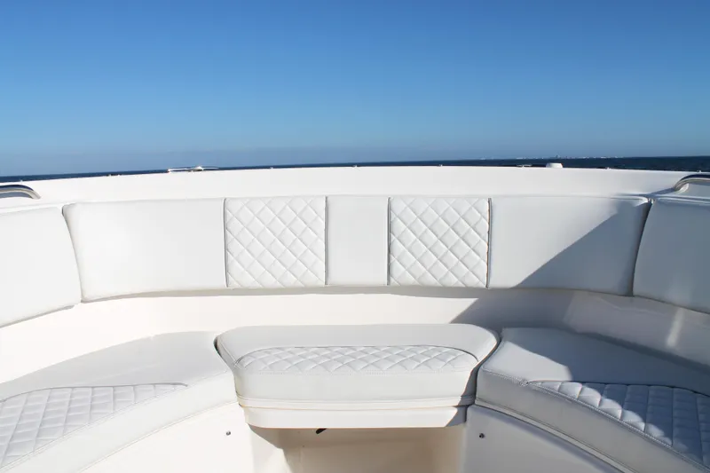 Slide: The Image of 2023 Pursuit S 378 Sport boat with white cushioned seating under clear blue sky. - 52