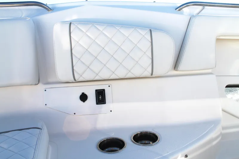 Slide: The Image of 2023 Pursuit S 378 Sport boat interior with quilted upholstery and cup holders. - 54