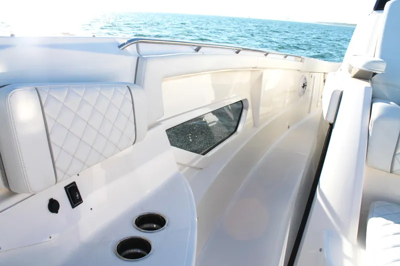 Slide: The Image of 2023 Pursuit S 378 Sport boat interior with white seating and ocean view. - 56
