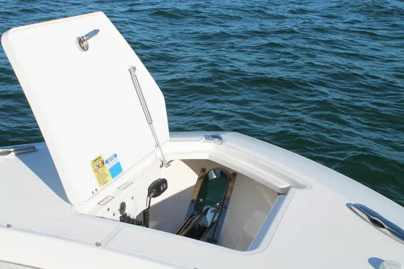 Slide: The Image of 2023 Pursuit S 378 Sport boat anchor compartment open on calm water. - 58