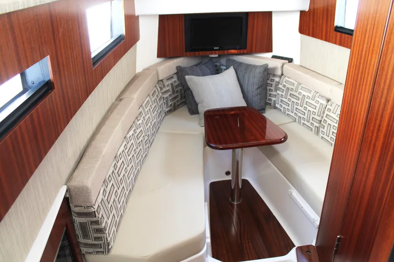 Slide: The Image of Luxurious interior of 2023 Pursuit S 378 Sport boat with elegant seating and wooden table. - 59