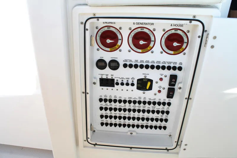 Slide: The Image of Control panel of 2023 Pursuit S 378 Sport boat, featuring engine and generator switches. - 66