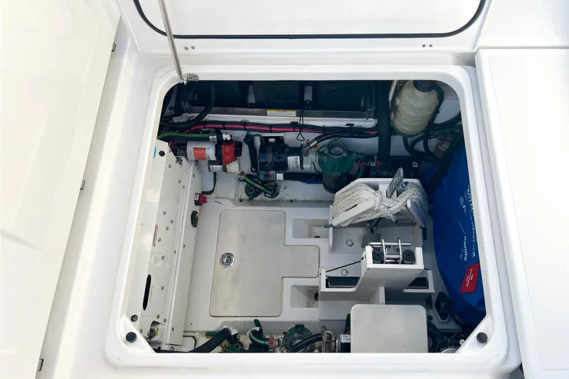 Slide: The Image of 2023 Pursuit S 378 Sport boat engine compartment with equipment and storage. - 67