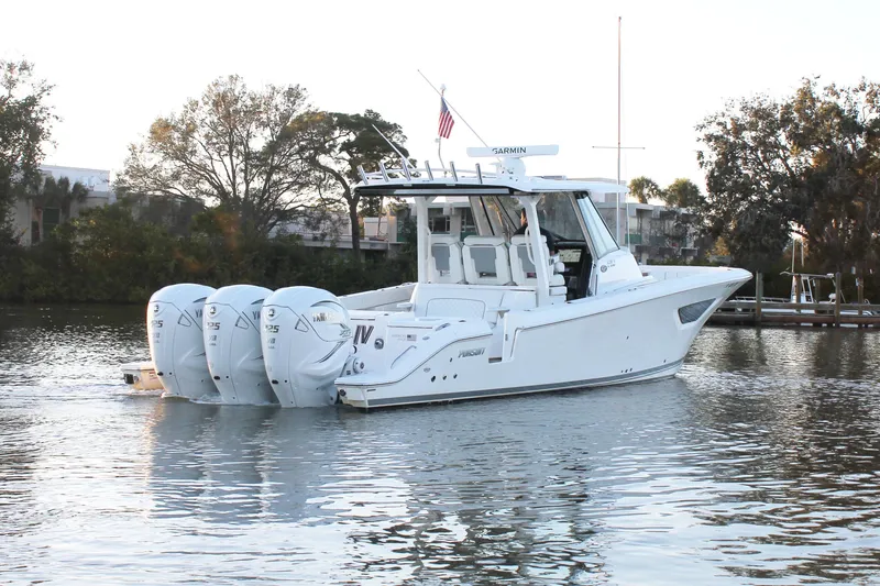Slide: The Image of 2023 Pursuit S 378 Sport boat with four engines on a calm waterway. - 8