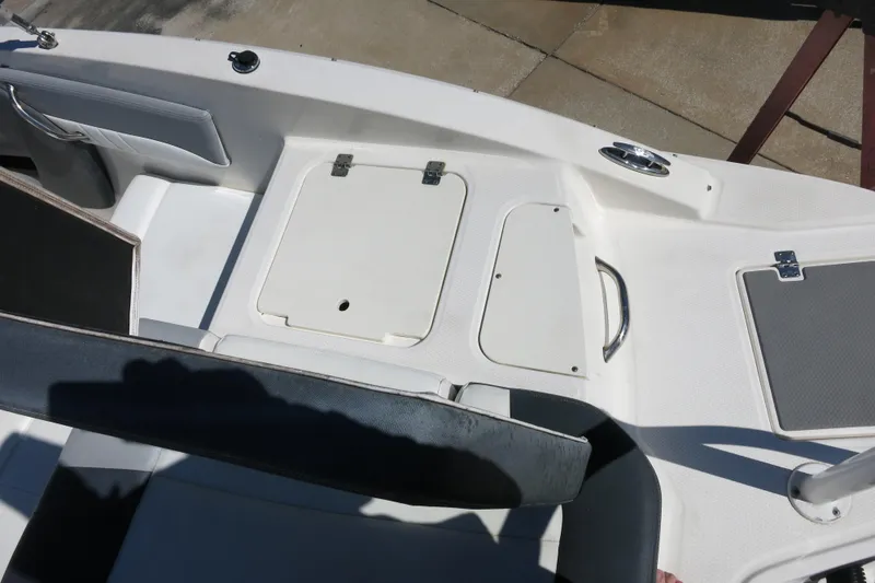 Slide: The Image of 2019 Chaparral 21 H2O Sport OB boat interior with storage compartments. - 11