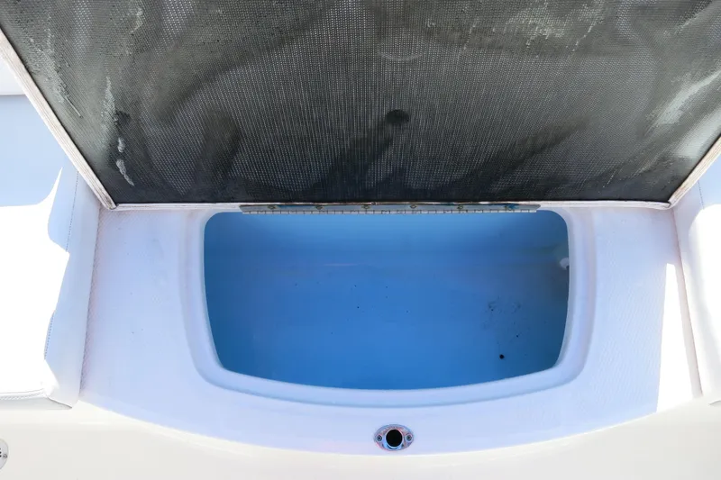 Slide: The Image of 2019 Chaparral 21 H2O Sport OB boat storage compartment, open and empty. - 13