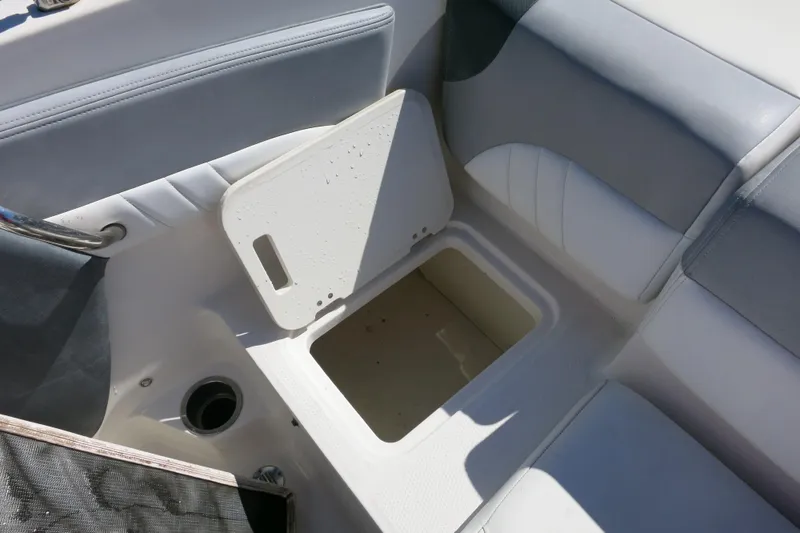 Slide: The Image of 2019 Chaparral 21 H2O Sport OB boat interior storage compartment with open lid. - 15