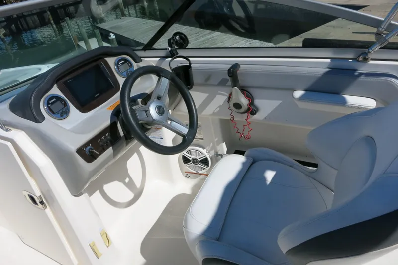Slide: The Image of 2019 Chaparral 21 H2O Sport OB boat interior with steering wheel and dashboard controls. - 16