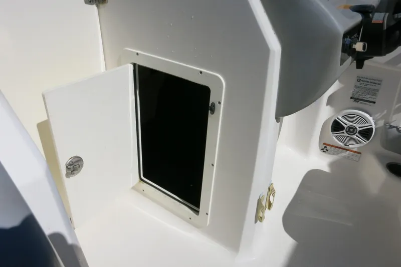 Slide: The Image of 2019 Chaparral 21 H2O Sport OB boat interior storage compartment with open door. - 20
