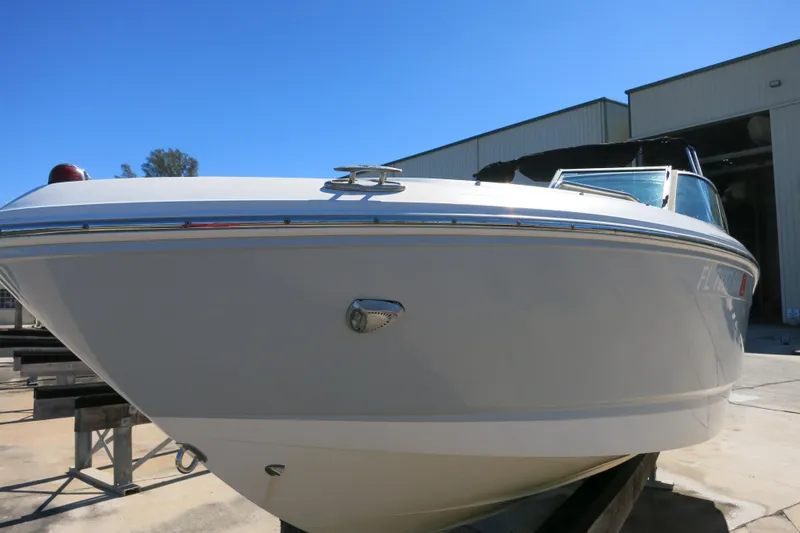 Slide: The Image of 2019 Chaparral 21 H2O Sport OB boat in a sunny outdoor setting. - 6