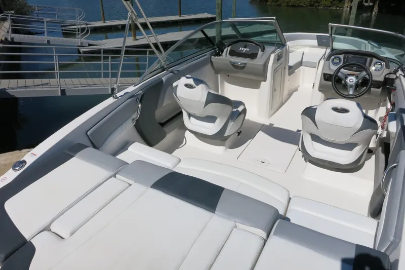 Slide: The Image of 2019 Chaparral 21 H2O Sport OB boat interior with seating and steering wheel. - 9