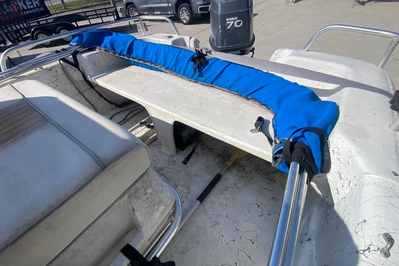 Slide: The Image of 2007 Carolina Skiff 1780 DLX interior with blue cover and Yamaha 70 outboard motor. - 17