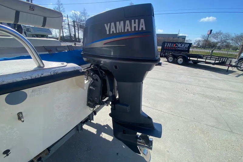 Slide: The Image of 2007 Carolina Skiff 1780 DLX with Yamaha outboard motor in a parking lot. - 19