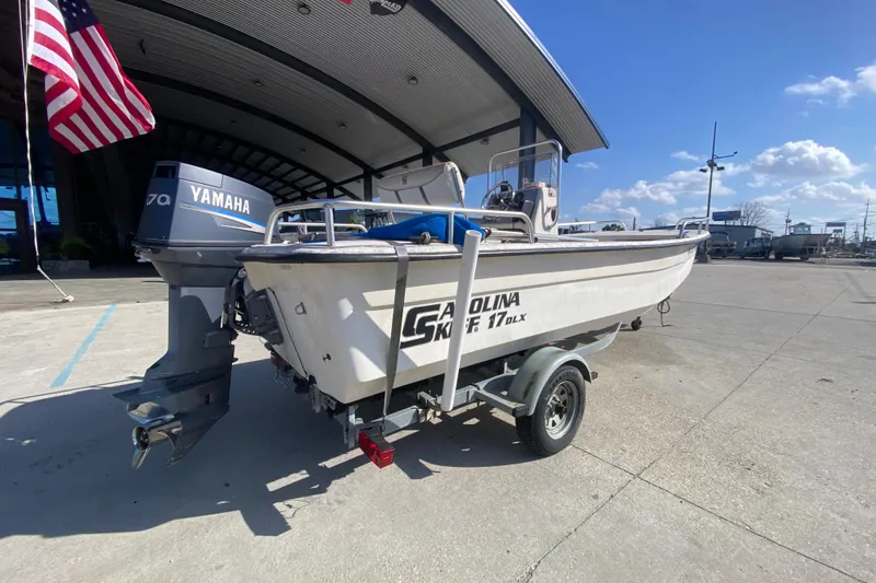 Slide: The Image of 2007 Carolina Skiff 1780 DLX boat with Yamaha motor on trailer, parked outdoors. - 4