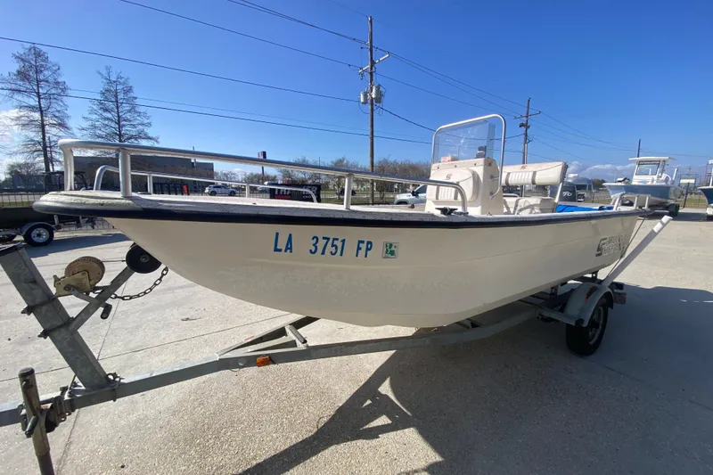 Slide: The Image of 2007 Carolina Skiff 1780 DLX boat on trailer under clear blue sky. - 8
