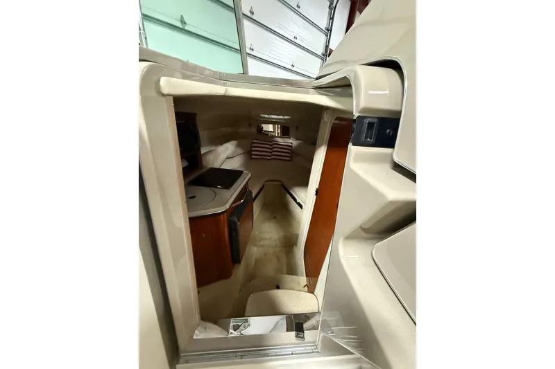Slide: The Image of Interior view of 2007 Sea Ray 240 Sundancer cabin with kitchenette and seating area. - 11