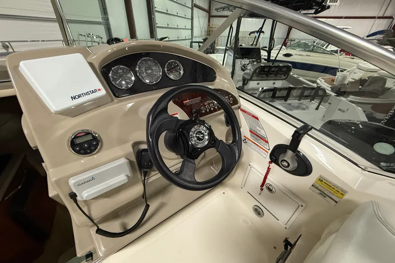 Slide: The Image of 2007 Sea Ray 240 Sundancer helm with Northstar and Garmin navigation systems. - 12