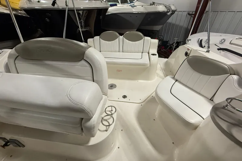 Slide: The Image of 2007 Sea Ray 240 Sundancer boat interior with white seating and cup holders. - 14