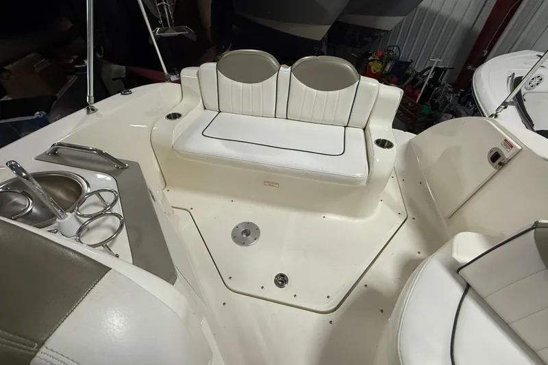 Slide: The Image of 2007 Sea Ray 240 Sundancer boat interior with seating and cup holders. - 16