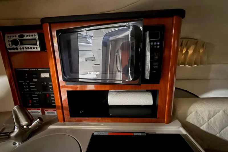Slide: The Image of Interior of 2007 Sea Ray 240 Sundancer with microwave, paper towel holder, and control panel. - 17