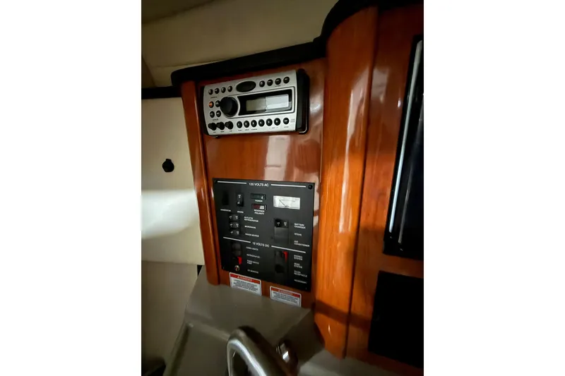 Slide: The Image of 2007 Sea Ray 240 Sundancer control panel with stereo system and electrical switches. - 18