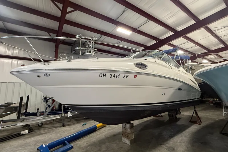 Slide: The Image of 2007 Sea Ray 240 Sundancer boat in indoor storage, side view. - 21