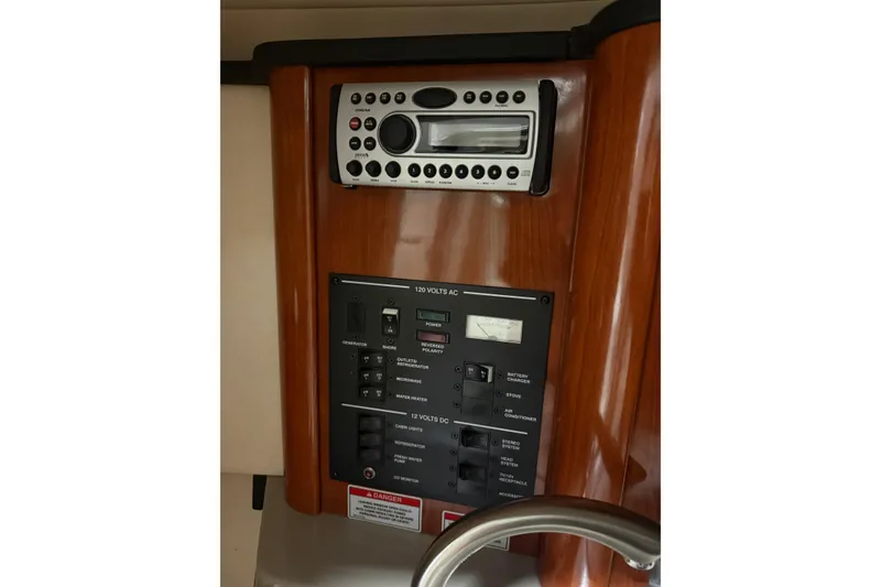 Slide: The Image of 2007 Sea Ray 240 Sundancer control panel with stereo and electrical switches. - 5