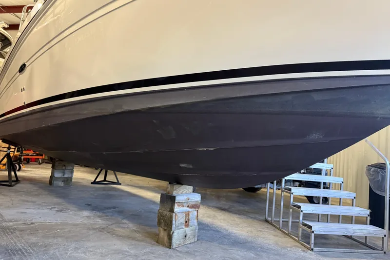 Slide: The Image of 2007 Sea Ray 240 Sundancer boat on blocks in a storage facility. - 6