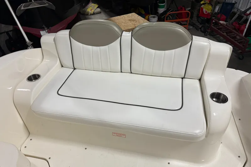 Slide: The Image of White leather seating on a 2007 Sea Ray 240 Sundancer boat with cup holders. - 7