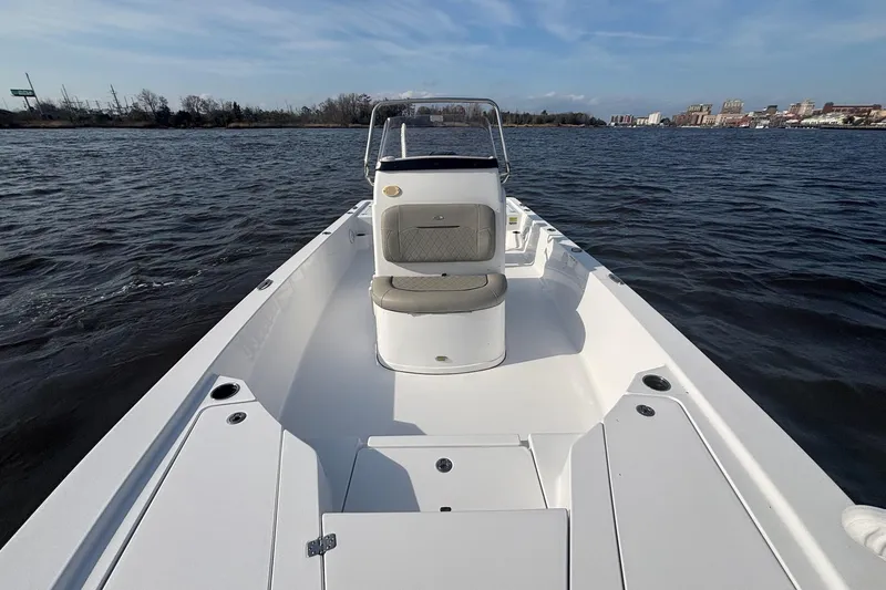 Slide: The Image of 2022 Sportsman Tournament 234 Bay Boat on calm water, showcasing spacious deck and seating. - 10