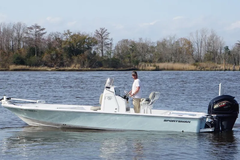 Slide: The Image of 2022 Sportsman Tournament 234 Bay Boat on a calm river with trees in the background. - 4