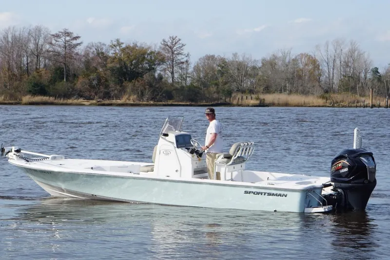 Slide: The Image of 2022 Sportsman Tournament 234 Bay Boat on a calm river with trees in the background. - 5