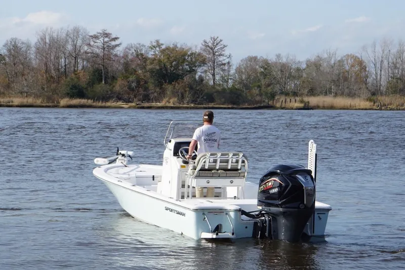 Slide: The Image of 2022 Sportsman Tournament 234 Bay Boat on a calm river with trees in the background. - 6