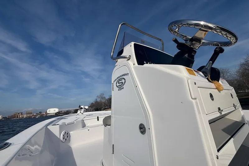 Slide: The Image of 2022 Sportsman Tournament 234 Bay Boat on water under clear blue sky. - 7