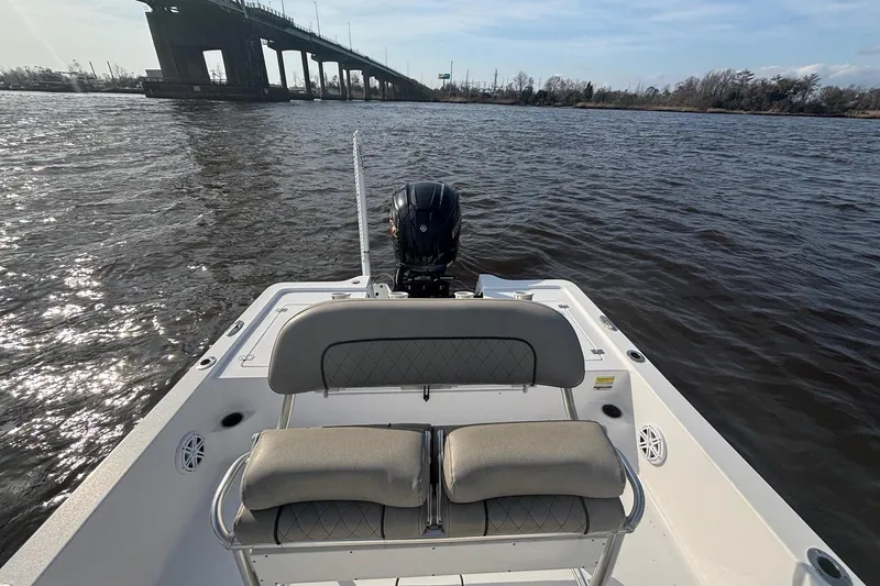Slide: The Image of 2022 Sportsman Tournament 234 Bay Boat on water near a bridge, rear seating view. - 9