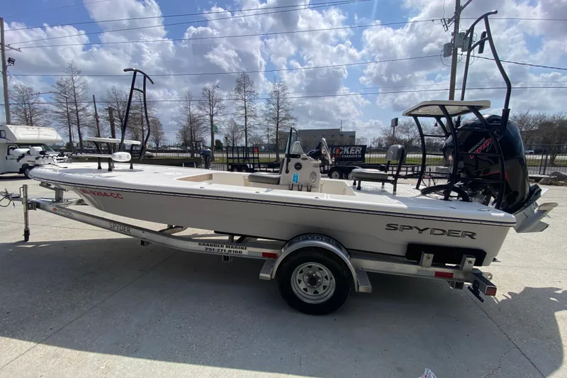 Slide: The Image of 2022 Composite Research Spyder FX-19 Vapor boat on trailer, parked outdoors under cloudy sky. - 11
